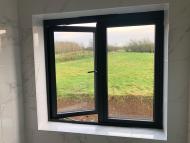 internal view from a gable windows of a converted traditional rural scottish property showcasing an aluminium juliet window - one window open