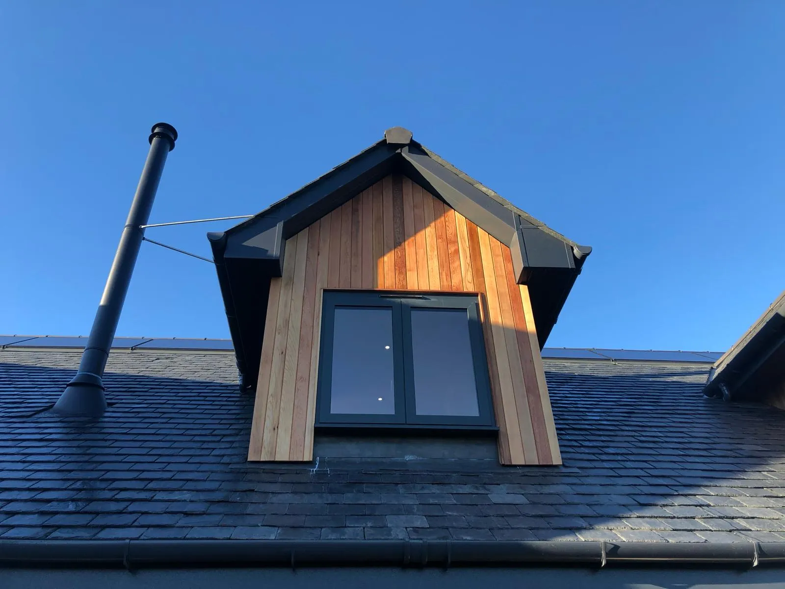 gable windows of a converted traditional rural scottish property showcasing timber cladding and aluminium juliet windows