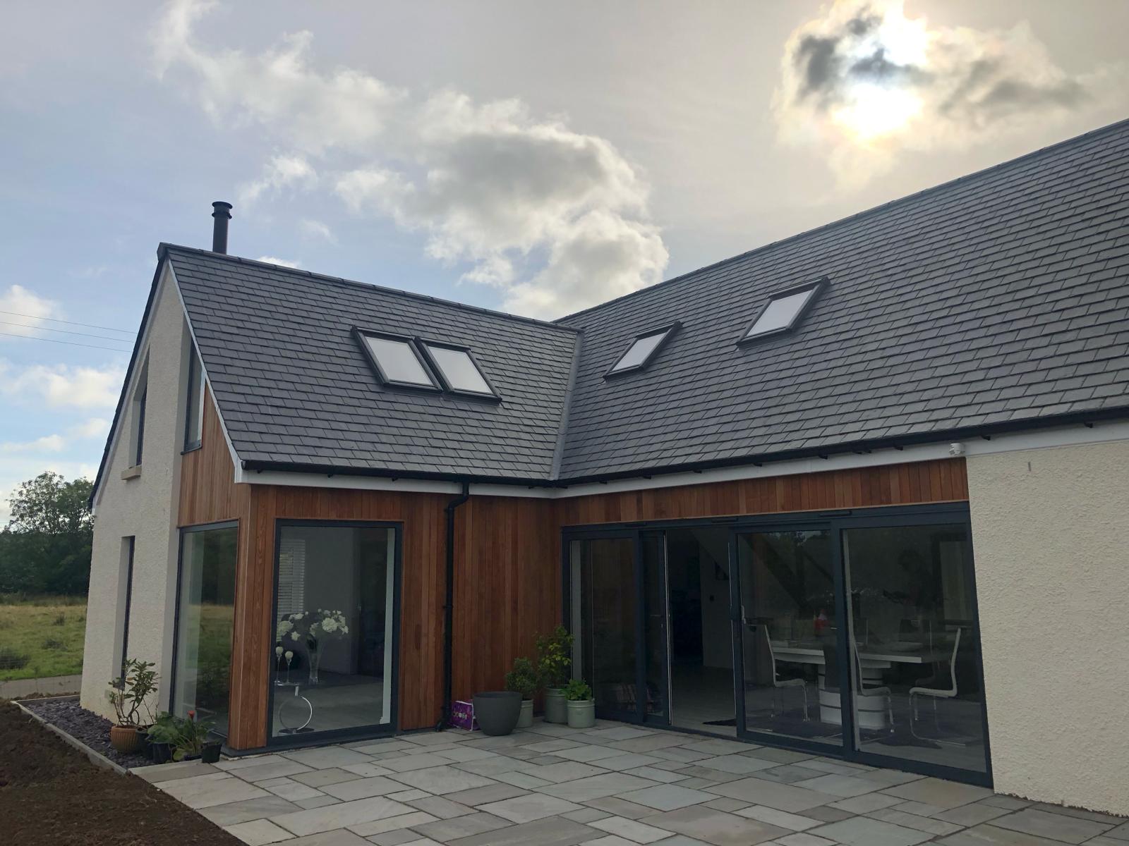 rear view of a traditional rural cottage show casing aluminium sliding doors and windows